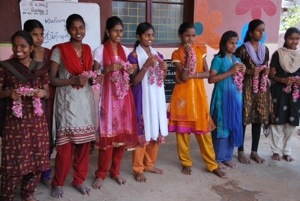 The home children have prepared flower necklaces