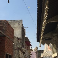 Children playing with the kites on the top of the roofs